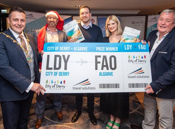 Sarah Simpson and Michael Daly who won Travel Solutions holiday to Portugal Mayor's Christmas Charity Night in aid of Foyle Down Syndrome Trust pictured receiving their prize from Alderman Graham Warke and Robert Wilson from Travel Solutions and Steve Frazer, City of Derry Airport Managing Director.