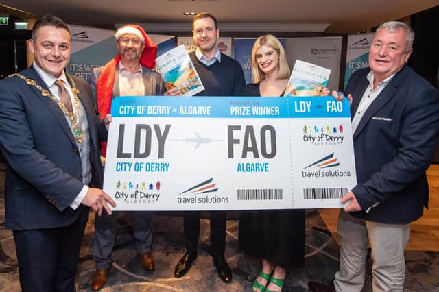 Sarah Simpson and Michael Daly who won Travel Solutions holiday to Portugal Mayor's Christmas Charity Night in aid of Foyle Down Syndrome Trust pictured receiving their prize from Alderman Graham Warke and Robert Wilson from Travel Solutions and Steve Frazer, City of Derry Airport Managing Director.