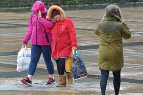 STORM BRENDAN JANUARY 2020: People walking across Guildhall Square after torrential rain and high winds brought by Storm Brendan. There are similar warnings in place for Storm Barra today. DER0220GS – 007