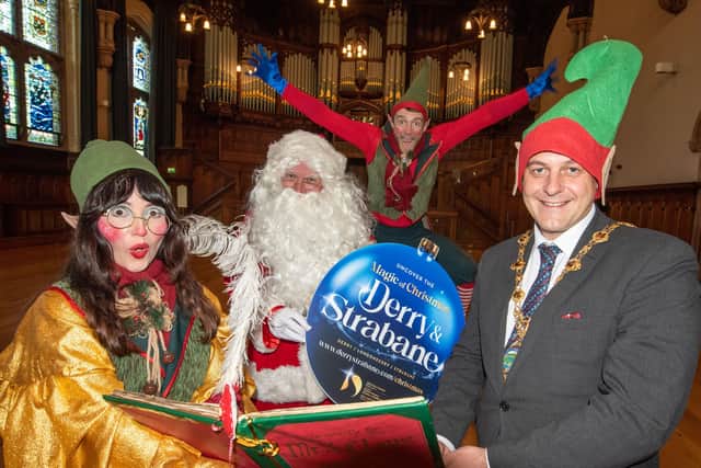 Derry City and Strabane District Council Mayor Alderman Graham Warke attempts to discover wether he is on Santa's naughty or nice list at the launch of this years programme of events. Picture Martin McKeown. 09.11.21