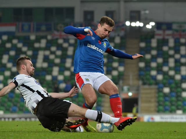 New Derry City signing Cameron Dummigan pictured in action for Dundalk against Linfield's Mathew Clarke in the Unite the Union Cup at Windsor Park.