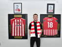 Brandon Kavanagh pictured beside portraits of club legends Ryan McBride and Mark Farren inside the Brandywell Stadium when signing this week