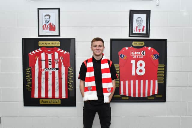 Brandon Kavanagh pictured beside portraits of club legends Ryan McBride and Mark Farren inside the Brandywell Stadium when signing this week