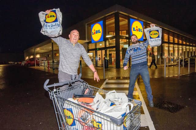 Connell Wilson, Lidl Trolly Dash winner at the Buncrana Road store, celebrates with deputy manager Stephen Coyle.