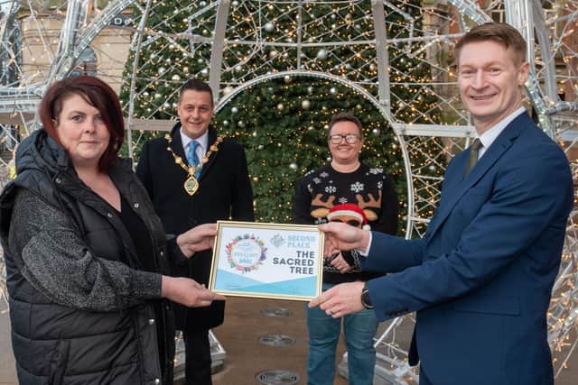 Helen Lilley from The Sacred Tree receives Second Prize in the City Centre Initiative Twelve Windows of Christmas competition from Conor Friel from the City Hotel, sponsor. Included are the Mayor Alderman Graham Warke and Lorraine Allen, Project Manager at City Centre Initiative. Picture Martin McKeown. 13.12.21