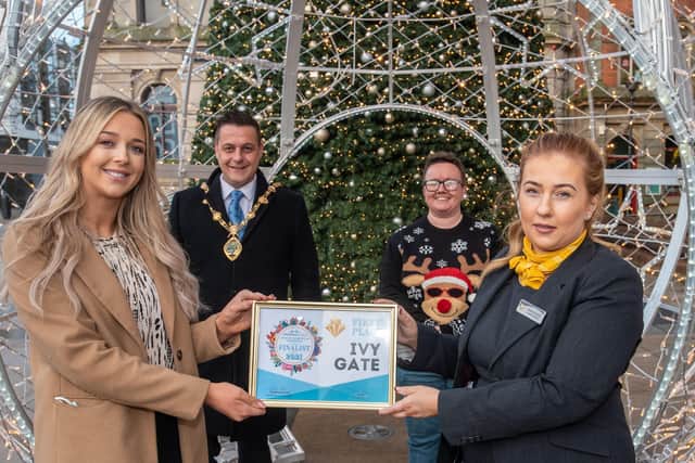 Helen Donaghy from Ivy Gate receives First Prize in the City Centre Initiative Twelve Windows of Christmas competition from Amanda Moran from the Maldron Hotel, sponsor. Included are the Mayor Alderman Graham Warke and Lorraine Allen, Project Manager at City Centre Initiative. Picture Martin McKeown. 13.12.21
