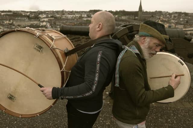 Lambeg drummer Richard Campell and Kila's Rónán " Snodaigh on the Derry Walls