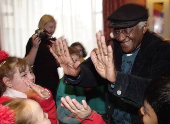 PACEMAKER BELFAST, 5/11/2001:  Archbishop Desmond Tutu from South Africa chats with schoolgirls from Holy Cross School in Belfast.  Archbishop Tutu was in Belfast to address a human rights conference organised by the Committee for the Administration of Justice.  PICTURE BY STEPHEN DAVISON