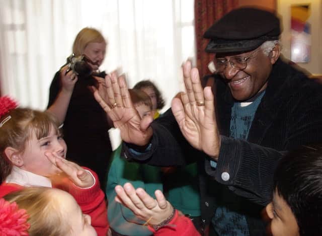 PACEMAKER BELFAST, 5/11/2001: Archbishop Desmond Tutu from South Africa chats with schoolgirls from Holy Cross School in Belfast. Archbishop Tutu was in Belfast to address a human rights conference organised by the Committee for the Administration of Justice. PICTURE BY STEPHEN DAVISON