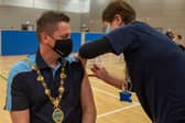 The Mayor, Alderman Graham Warke receives his Covid-19 vaccination booster in the Foyle Arena from Kathleen Crossan who was a district nurse before retiring. Picture Martin McKeown. 15.12.21