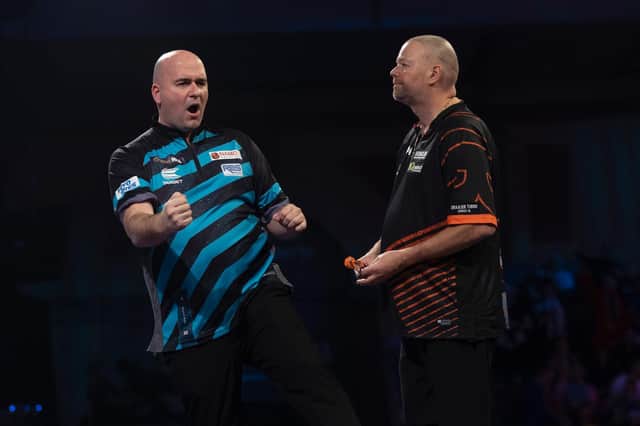 Rob Cross celebrates his win over Raymond van Barneveld in the clash of former winners in the William Hill World Darts Championship second round.