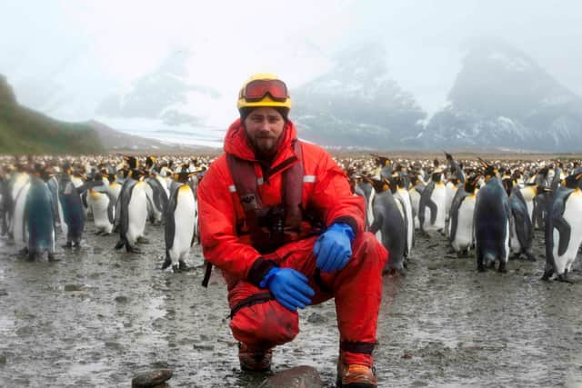 Matt Neill surrounded by some Antarctic friends.