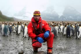 Matt Neill surrounded by some Antarctic friends.