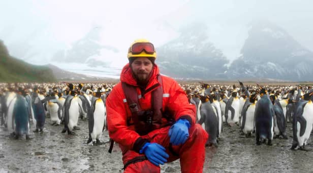 Matt Neill surrounded by some Antarctic friends.