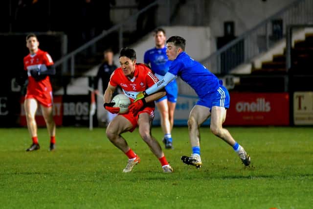 Derry’s Shea Downey holds possession under pressure from Monaghan’s Darragh Downey. (Photo: George Sweeney)