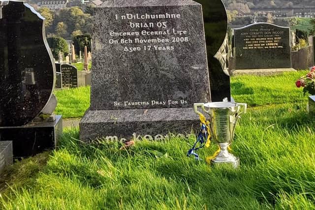 The Derry Intermediate title resting at the foot of Brian Og McKeever's grave after victory over Greenlough last November.