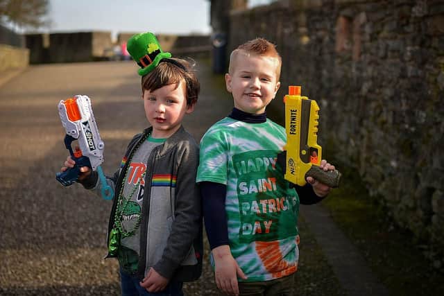 Cousins Aodhan Gillespie, aged 5, and Brandain Crossan (6) walked around Derry Walls on St Patrick’s Day. Photos: George Sweeney / Derry Journal.  DER2110GS – 024
