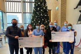 The family of the late Bobby Mullan presents a donation to staff.