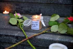 Candle and message at the vigil for Ashling Murphy held at the Guildhall Steps on Friday afternoon. Photo: George Sweeney.  DER2202GS – 081