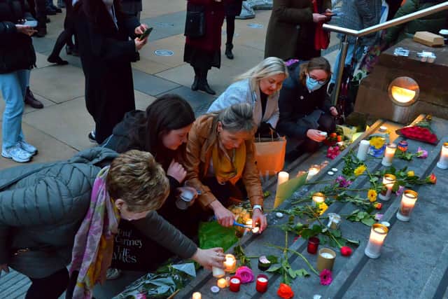 Martina Anderson and Karen Mullan were among the many women attending the vigil for Ashling Murphy who placed candles and flowers on the Guildhall Steps on Friday afternoon. Photo: George Sweeney.  DER2202GS – 083