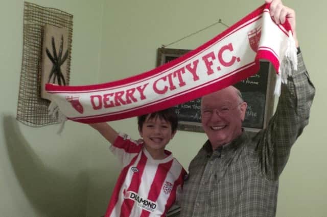 Jimmy with grandson Leo Seamus, wearing their Derry City FC colours with pride.