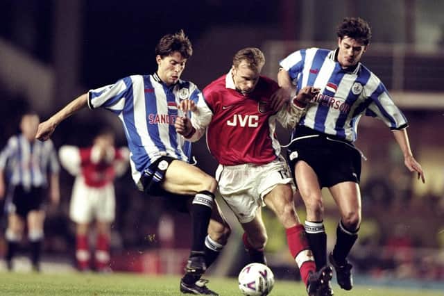 Dennis Bergkamp of Arsenal battles with Petter Rudi and Danny Sonner of Sheffield Wednesday at Highbury.