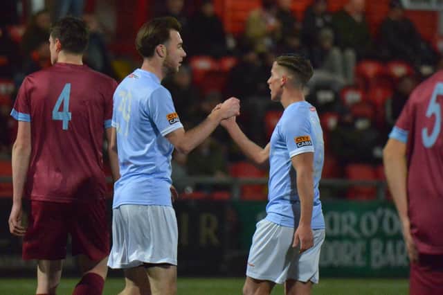 Derry City's Evan McLaughlin congratulates trialist Louis Britton after his first half goal. Picture: George Sweeney