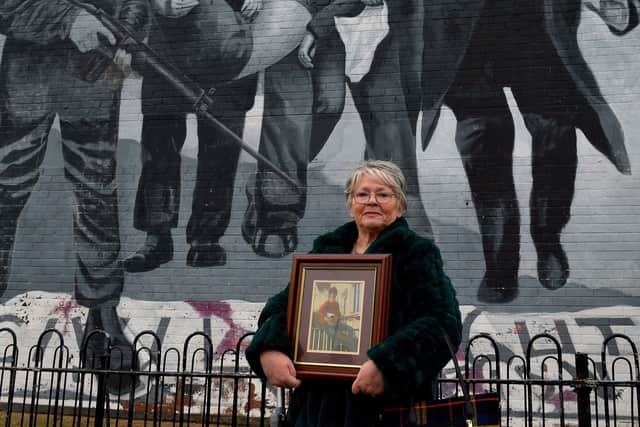 Kate Nash pictured at the Bloody Sunday mural in Rossville Street, with a photograph of her 19 year-old brother William who was killed on Bloody Sunday. Photo: George Sweeney.  DER2203GS – 018