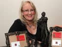 Anne Marie O Hara with some of her art pieces.