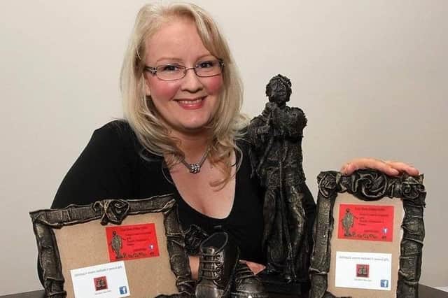 Anne Marie O Hara with some of her art pieces.