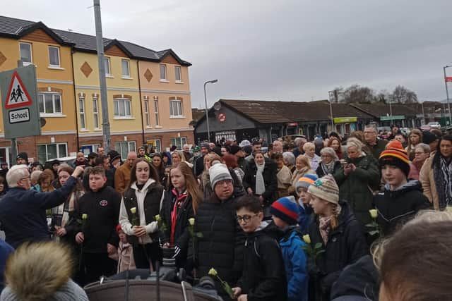 Children hold white roses at the front of the Bloody Sunday Walk of Remembrance this morning.