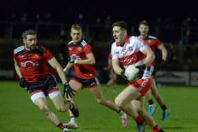 Down’s Kevin McKernan closes in on Derry’s Padraig McGrogan in Owenbeg on Saturday evening last. DER2204GS – 055 (Photo: George Sweeney)