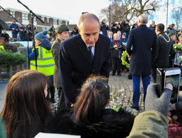 Taoiseach Micheál Martin speaking with relatives at the Bloody Sunday Monument, during a 50th anniversary Memorial Service, held on Sunday morning , in remembrance of those shot dead and wounded in 1972. Photo: George Sweeney, DER2205GS – 020