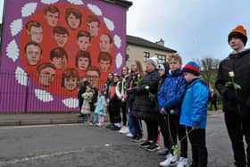Relatives pass the mural on Westland Street depicting those killed Bloody Sunday. Photo: George Sweeney, DER2205GS – 015