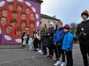 Relatives pass the mural on Westland Street depicting those killed Bloody Sunday. Photo: George Sweeney, DER2205GS – 015