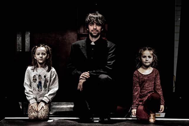 Conor O'Kane as Fr Tom O'Gara with child actors Seánann Ward and Arianna McLaughlin.