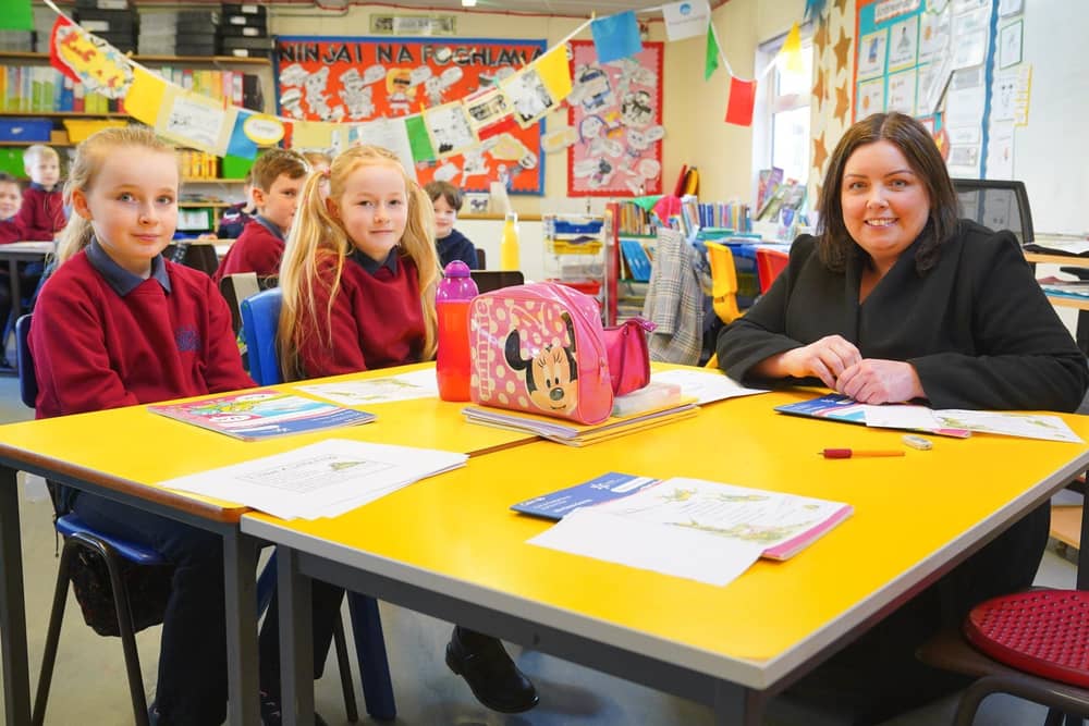 Communities Minister Deirdre Hargey is pictured with pupils from Scoil an Droichid on a visit to open the 2022 Líofa Gaeltacht Bursary Scheme