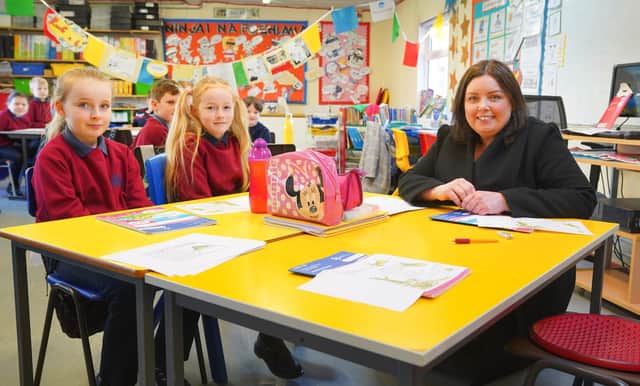 Communities Minister Deirdre Hargey is pictured with pupils from Scoil an Droichid on a visit to open the 2022 Líofa Gaeltacht Bursary Scheme