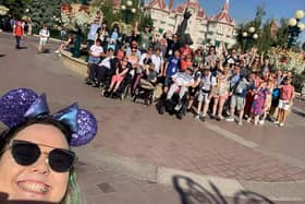 Aine McFadden, Team Leader at Tuned In, takes a 'selfie' with a group of students and staff who went on the first trip to Disney.