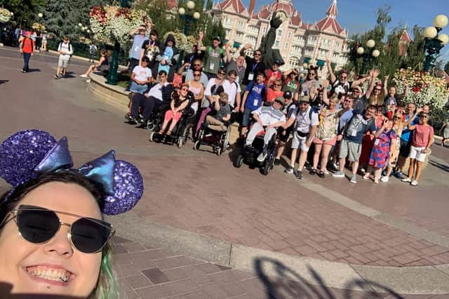Aine McFadden, Team Leader at Tuned In, takes a 'selfie' with a group of students and staff who went on the first trip to Disney.