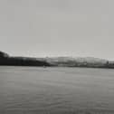 Snow visible lying on higher ground behind Top of the Hill.