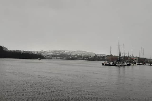 Snow visible lying on higher ground behind Top of the Hill.