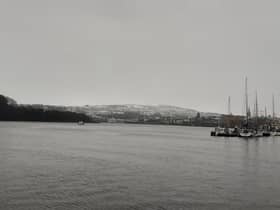 Snow visible lying on higher ground behind Top of the Hill.
