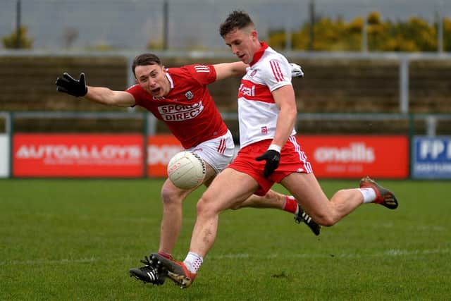 Derry forward Shane McGuigan scores one of his eight points against Cork in Owenbeg this afternoon. (Photo: George Sweeney)
