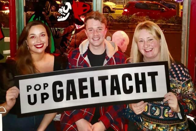 Brónach Crabtree, Tom Cosgrove & Mary Durkan with the Pop up Gaeltacht sign. The event will be happening on Friday, February 25 in the Taphouse.