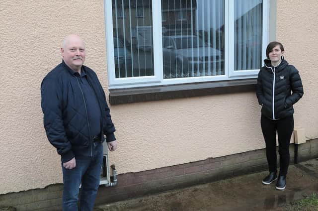 Housing Executive patch manager Deirdre Harkin with tenant Neil Hargan beside
one of the newly windows fitted at his home in Allingham Close, Ballymagroarty.