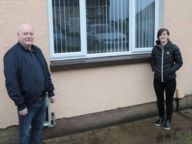 Housing Executive patch manager Deirdre Harkin with tenant Neil Hargan beside
one of the newly windows fitted at his home in Allingham Close, Ballymagroarty.