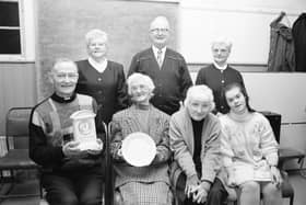 Father James McGlinchey, C.C., Desertegney, seated left, presenting gifts on behalf of the parish, to Tessie and Róis McLaughlin, seated second and third from left, on their retirement from Linsfort Post Office after more than sixty years of service to the community. They followed in the footsteps of their late father James McLaughlin, who opened the Post Office in 1927. Included are family members Bridie McLaughlin, Paddy McLaughlin, Bridget McLaughlin and Patricia McLaughlin.