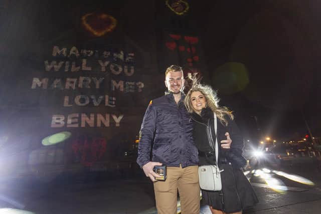 Benny Mamoin, from Newry, proposes to his girlfriend Mariane Freitas de Souza with the help of the projections onto the City's Guildhall during the Illuminate Festival. Photo Lorcan Doherty