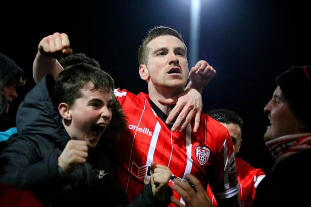 Patrick McEleney celebrates Friday night's big win over Shamrock Rovers with young Derry City supporters. Photograph by Kevin Moore.